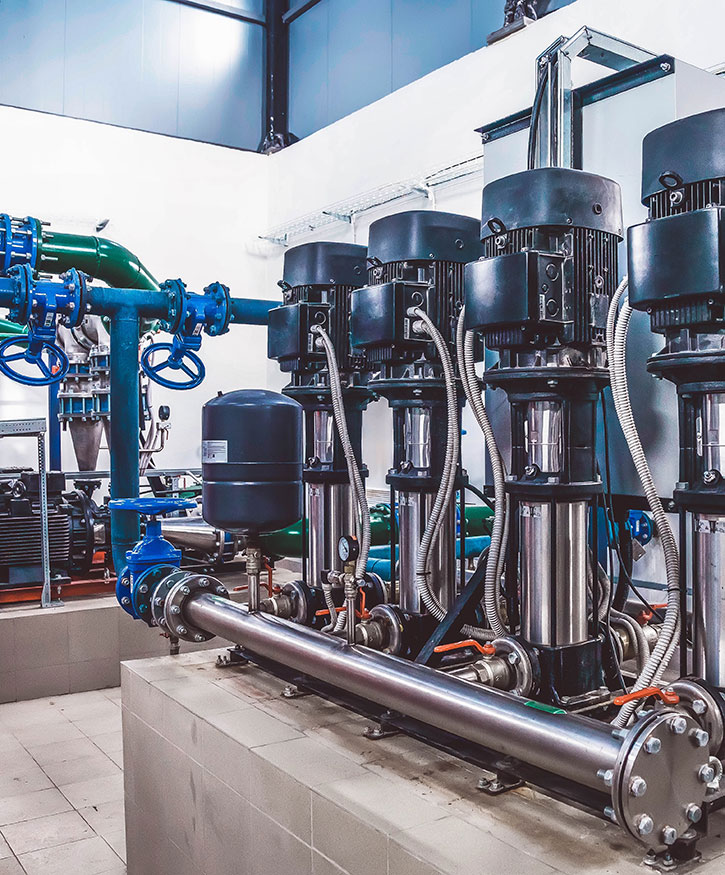 Room with a row of large industrial sized C and C pumps